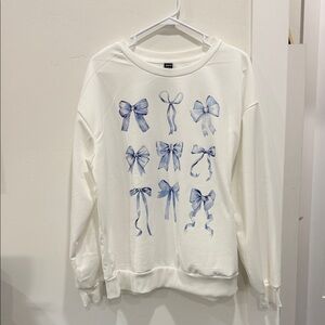 White Sweater with Blue Bow Design